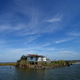 A camp heavily damaged by Hurricane Ida over the summer sits along shoreline that is retreating due to coastal erosion in Plaquemines Parish, La